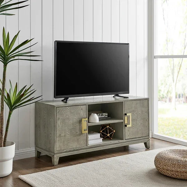 Light wood TV stand with gold handles and storage shelves in modern living room