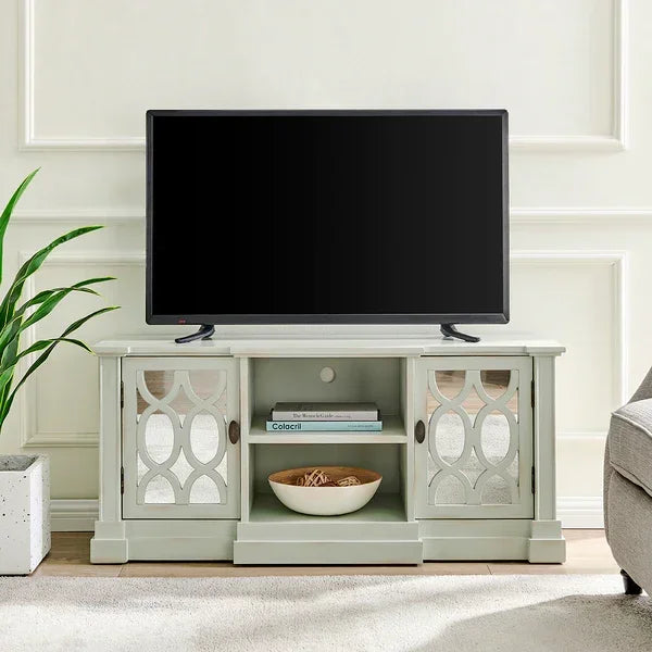Light grey mirrored TV unit with glass doors, open shelving and bowl decor in living room