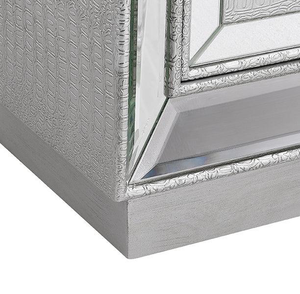 Silver mirrored furniture corner with embossed pattern and reflective glass detail