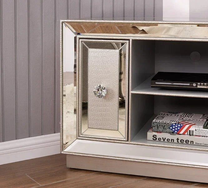 Mirrored TV unit with crystal handle, silver textured door, and open shelving on wood floor