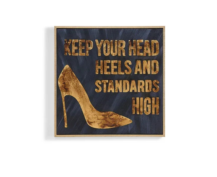 Gold high heel wall art with inspirational quote on black background