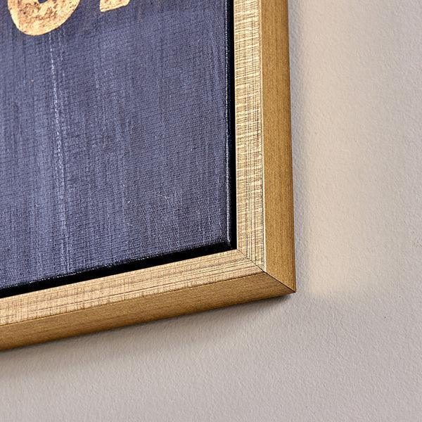 Gold frame wall art corner with navy background and partial text detail
