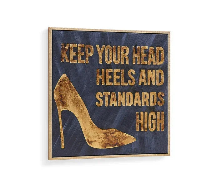 Decorative wall art with gold high heel and text Keep Your Head Heels and Standards High