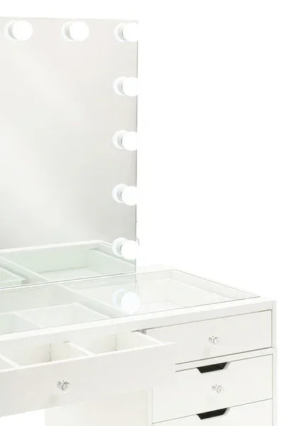 White dressing table with glass top, storage drawers, and mirror framed by LED bulbs