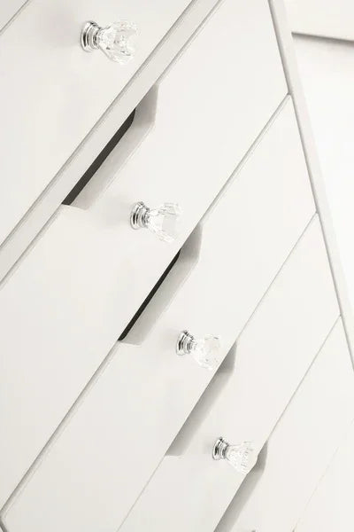 White chest of drawers with crystal handles, angled view highlighting modern bedroom furniture