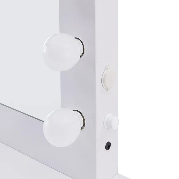 White dressing table mirror frame with LED bulbs and control buttons close-up view
