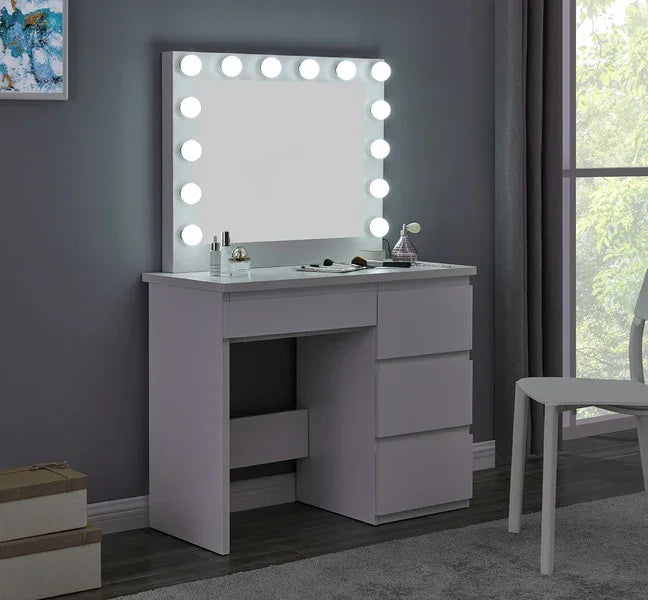 White dressing table with Hollywood mirror, drawers, and makeup items in modern bedroom