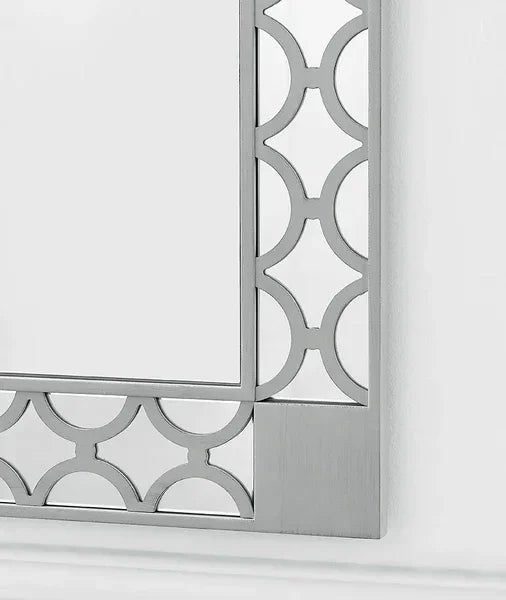 Silver wall mirror with geometric metal frame and modern design