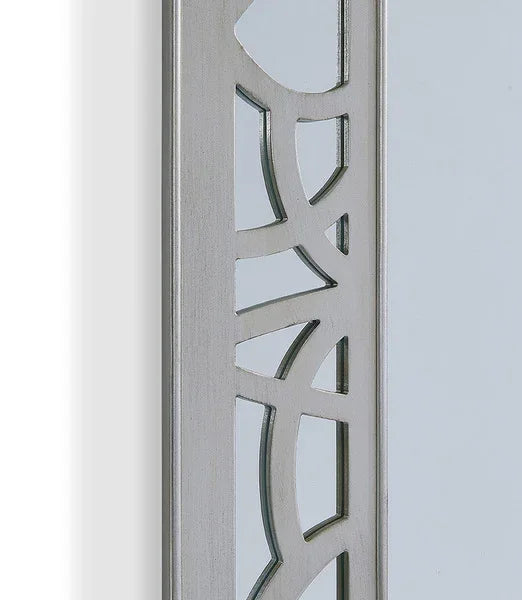 Close up of silver mirror frame with geometric cut-out metal design