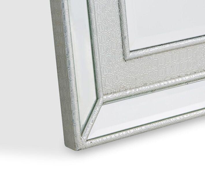 Silver decorative mirror frame detail with embossed geometric texture