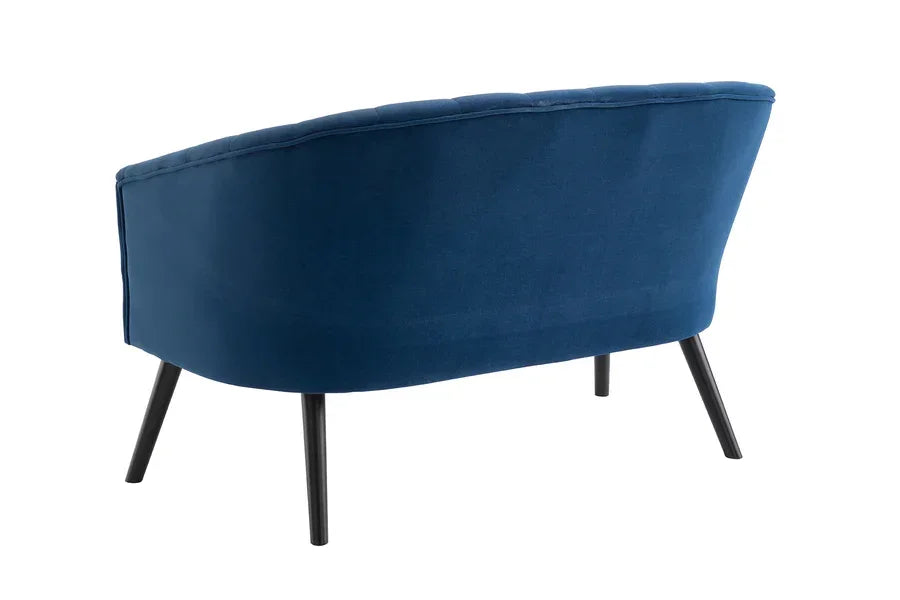 Rear angle of blue fabric sofa with curved backrest and tapered black legs