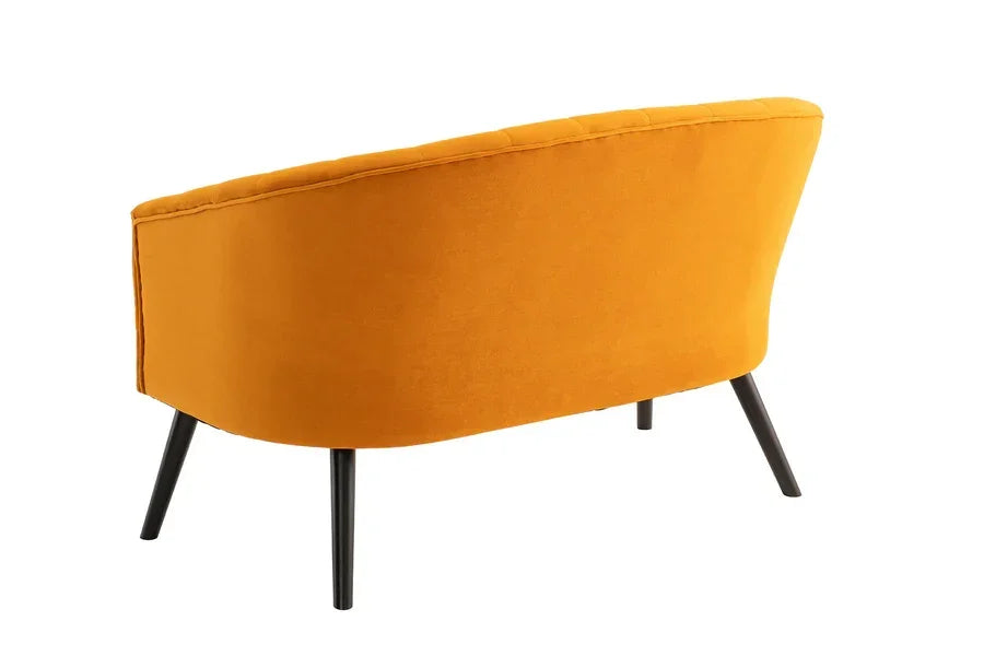 Mustard yellow velvet sofa with curved back and black metal legs, rear angle view