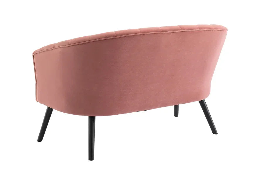 Blush pink fabric sofa with curved backrest and slim black legs, rear angle view