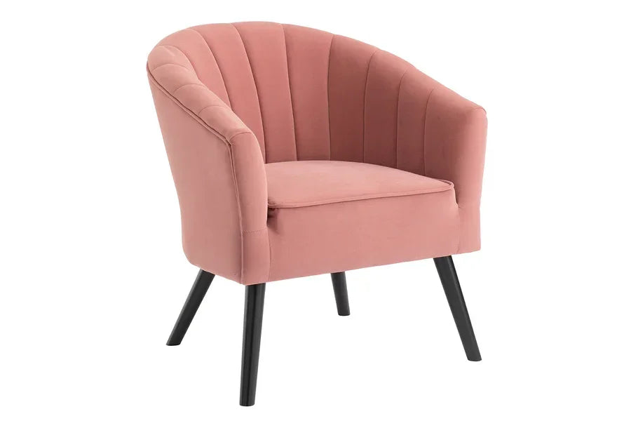 Blush pink velvet armchair with scalloped backrest and black angled legs