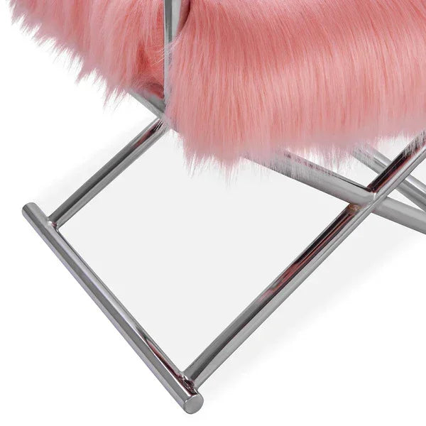 Pink faux fur chair seat with chrome metal legs, close up view of leg and upholstery