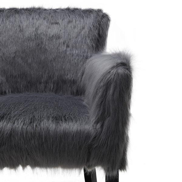 Grey faux fur accent chair with armrest and black legs, close-up front view