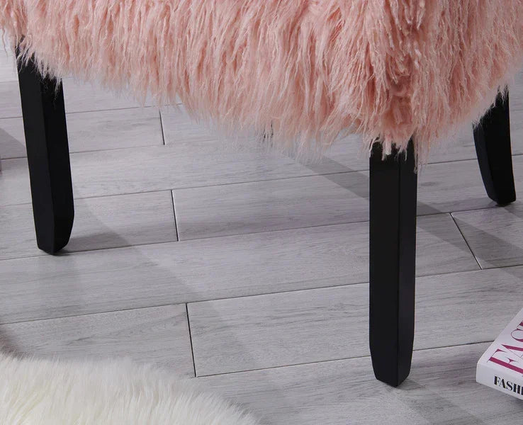 Pink faux fur bench with black legs on grey wood flooring