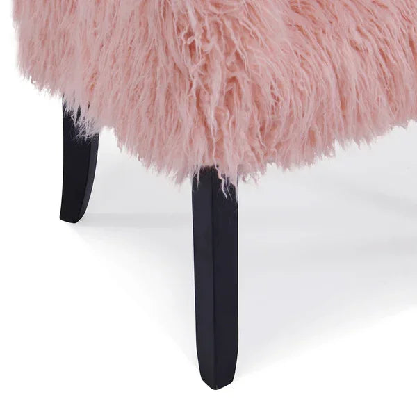 Pink faux fur footstool with black wooden legs close-up