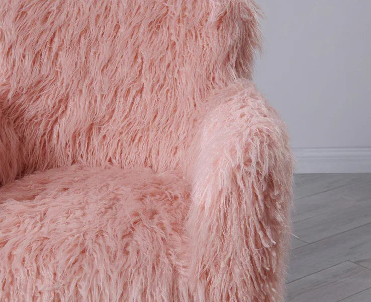 Light pink faux fur armchair with textured upholstery and angled wooden flooring