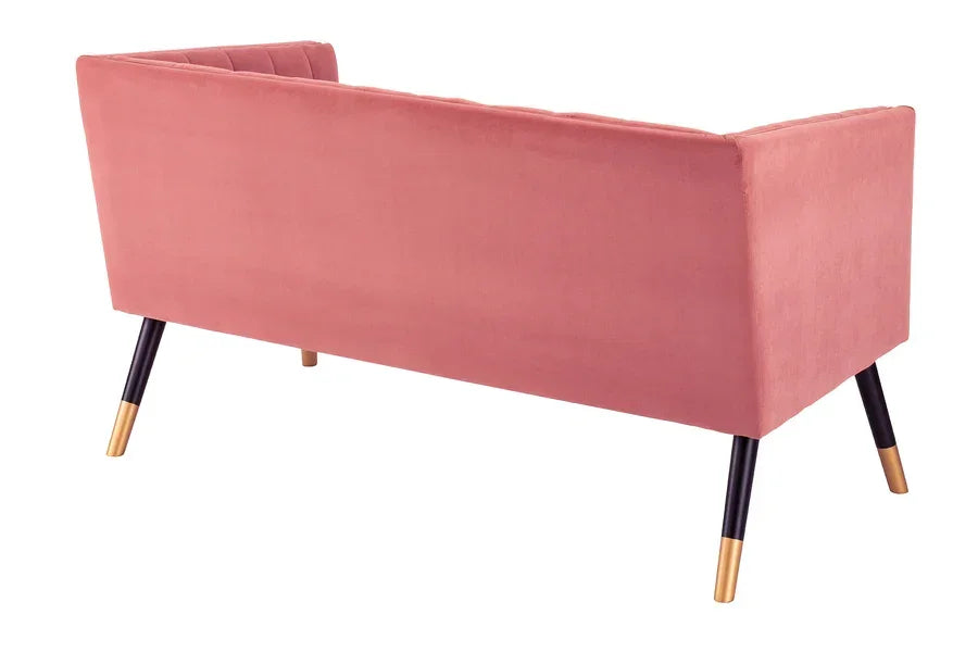 Rear view of pink velvet sofa with black and gold tapered legs