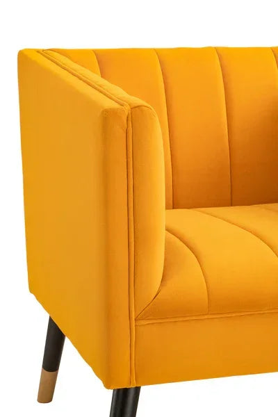 Close-up of yellow velvet sofa with channel tufted back and wooden legs
