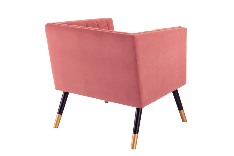 Back view of pink velvet armchair with black and gold tapered legs