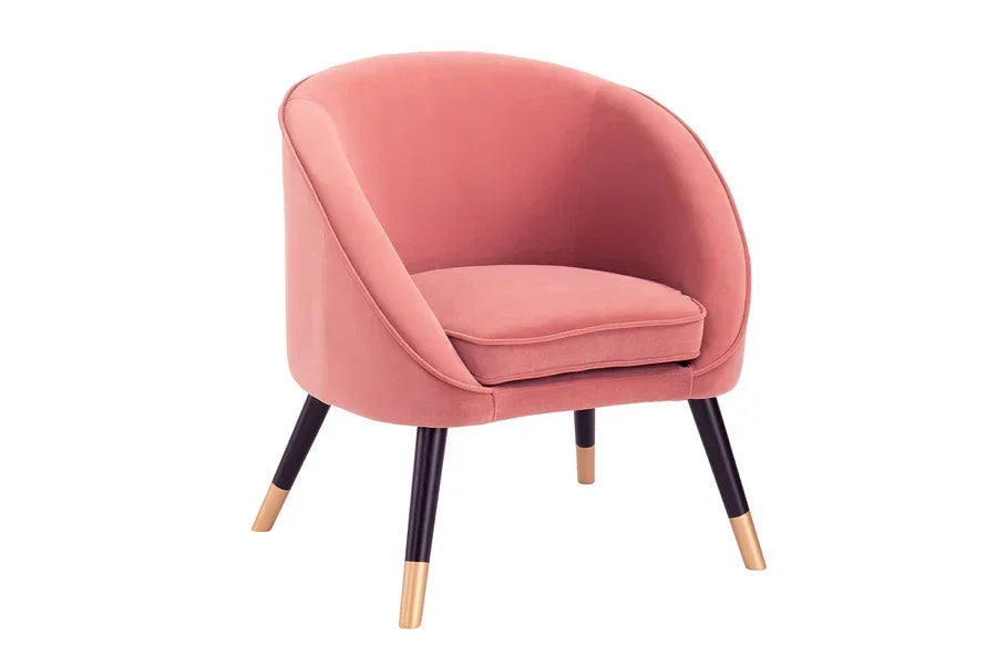 Pink velvet accent chair with black and gold legs, rounded back and seat cushion
