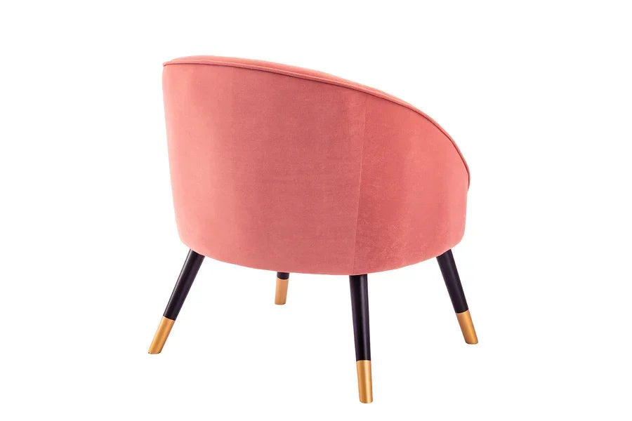 Blush pink accent chair with gold-tipped black legs, rear view on white background