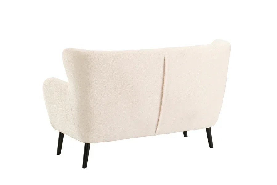 Rear view of cream fabric sofa with black metal legs