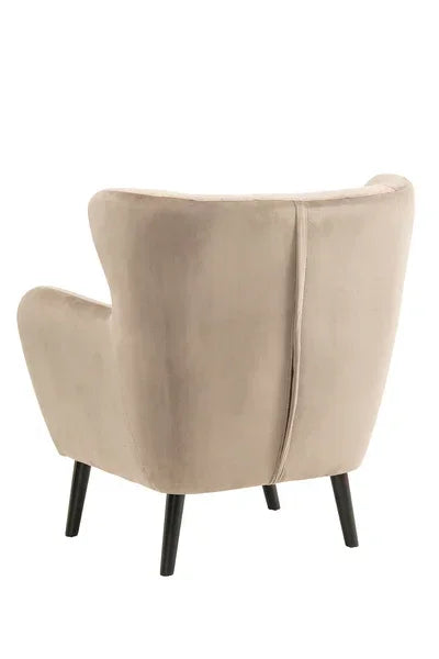 Beige velvet accent chair with black wooden legs, rear angle view