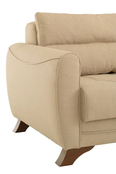 Beige fabric sofa arm with wooden legs and plush backrest, close-up side view