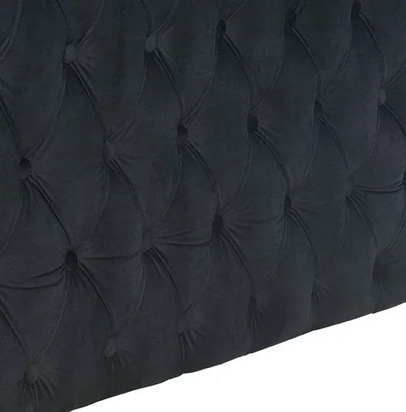 Dark velvet upholstered headboard with deep button tufting detail