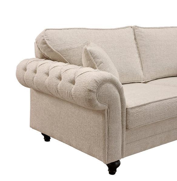 Beige fabric sofa with tufted rolled arm and dark wooden legs, close-up side view