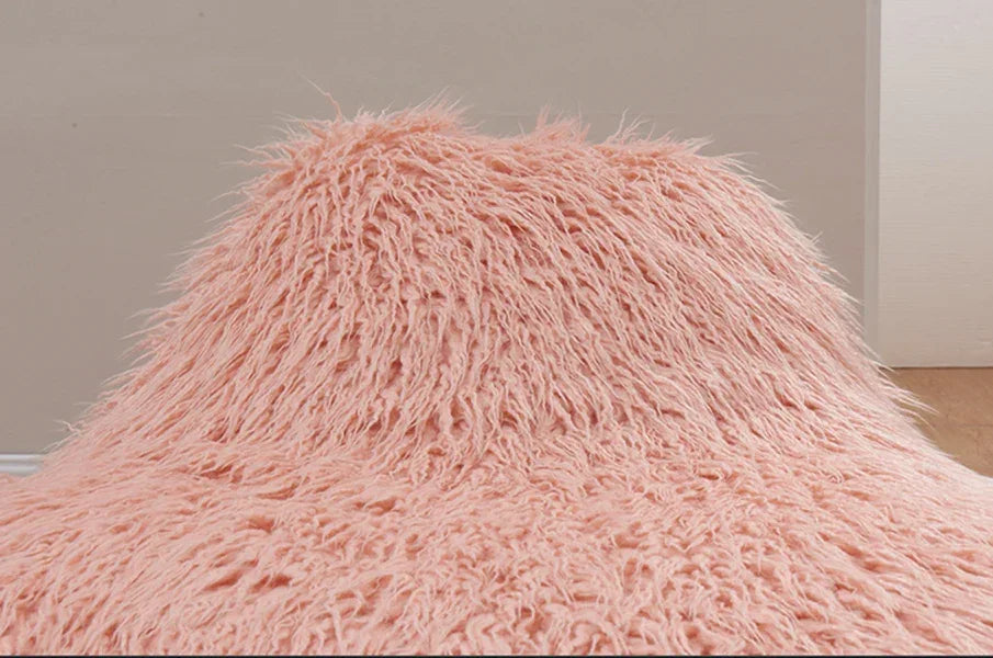 Pink shaggy faux fur bean bag chair in a neutral colored room
