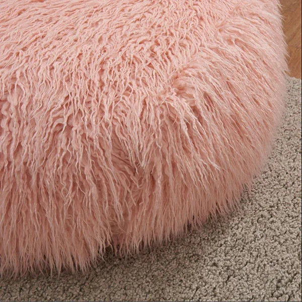 Blush pink faux fur bean bag chair on beige textured rug