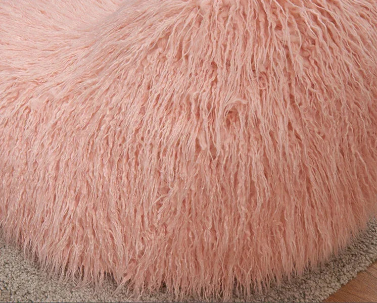 Blush pink faux fur bean bag chair on a beige carpet