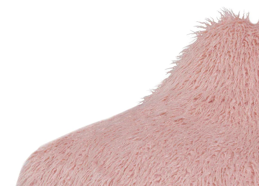 Close-up of pink faux fur cushion texture showing soft and fluffy surface detail