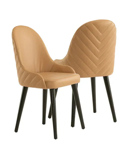 Tan leather dining chairs with black legs and chevron quilted backrests