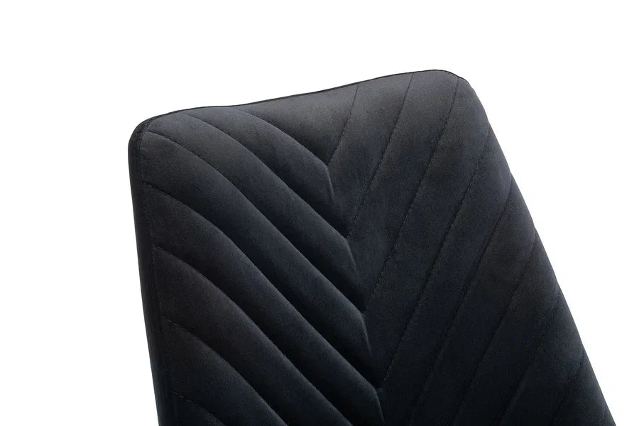 Close up of black velvet dining chair with chevron stitched backrest
