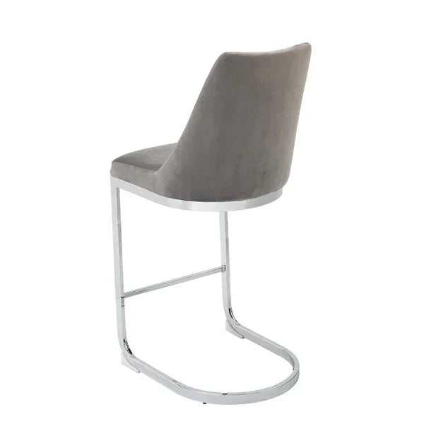 Grey velvet dining chair with chrome cantilever frame, rear angled view