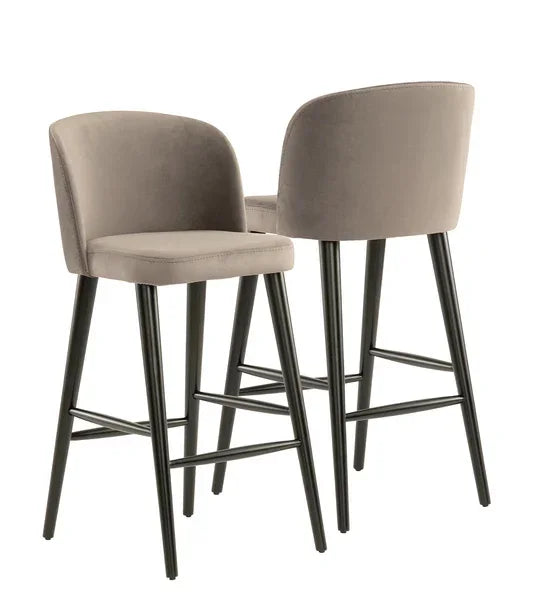 Pair of taupe velvet bar stools with black metal legs and low curved backs