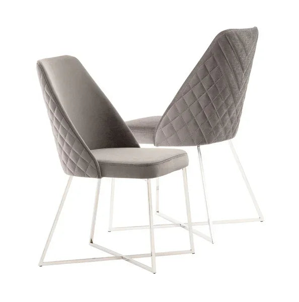 Grey velvet dining chairs with quilted backrest and metal sled legs, angled front and rear views