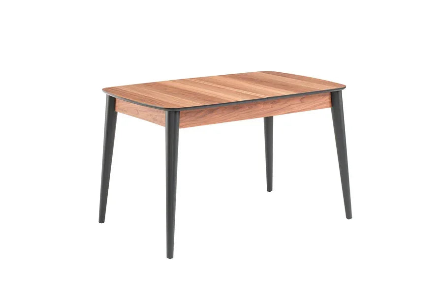 Rectangular wooden dining table with black angled legs on white background