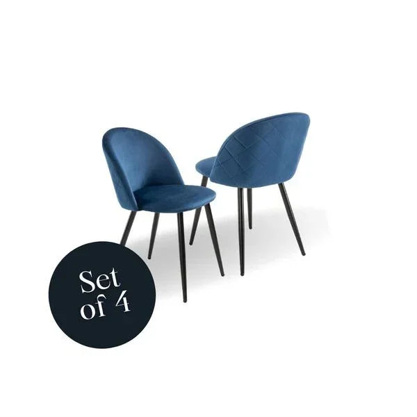 Set of four blue velvet dining chairs with black metal legs, angled front and back view