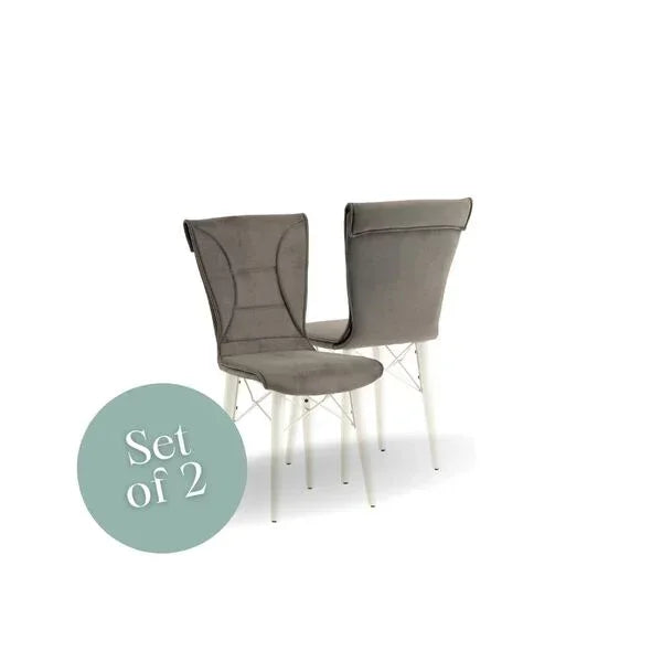 Set of two grey fabric dining chairs with white metal legs on white background