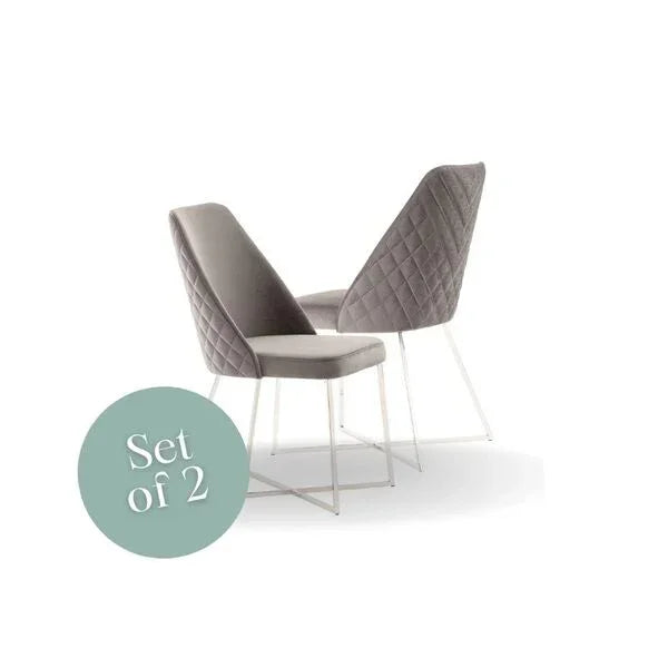 Set of two grey velvet dining chairs with quilted back and white metal legs