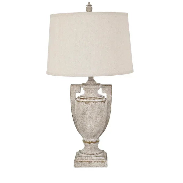 Antique-style table lamp with distressed urn base and cream fabric lampshade