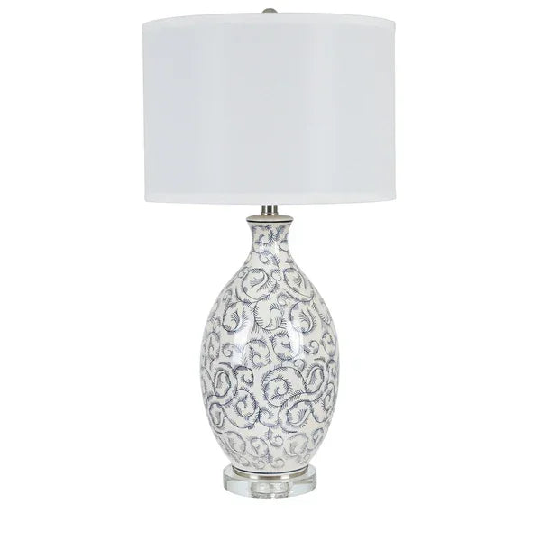 Ceramic table lamp with white and blue floral pattern and white drum shade