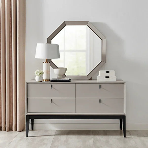 Modern sideboard with drawers, octagonal mirror, lamp and decor in living room