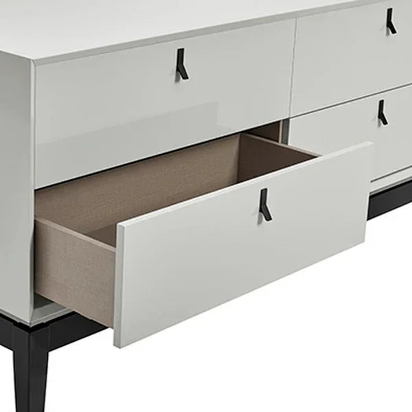 White gloss dresser with six drawers, one open to show spacious wood interior, black legs